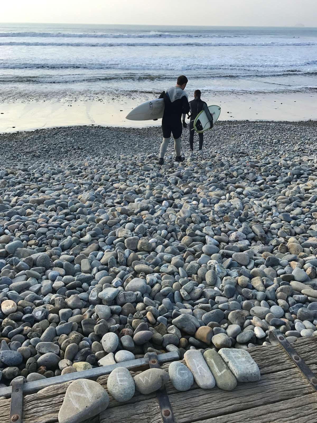 Two surfers on Newgale Beach Pembrokeshire