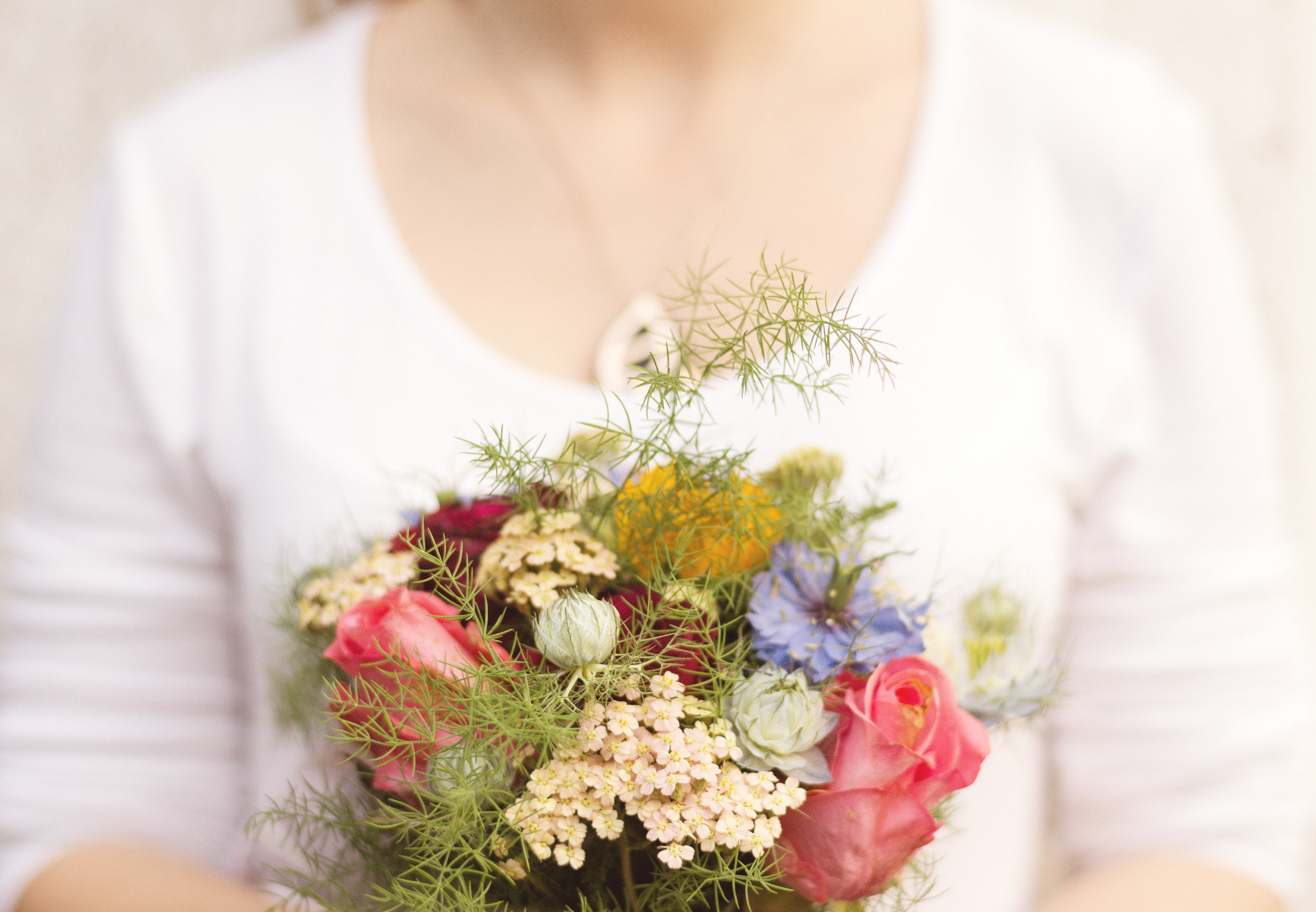 A woman holding a flower bouquet from our Standard Bouquet package