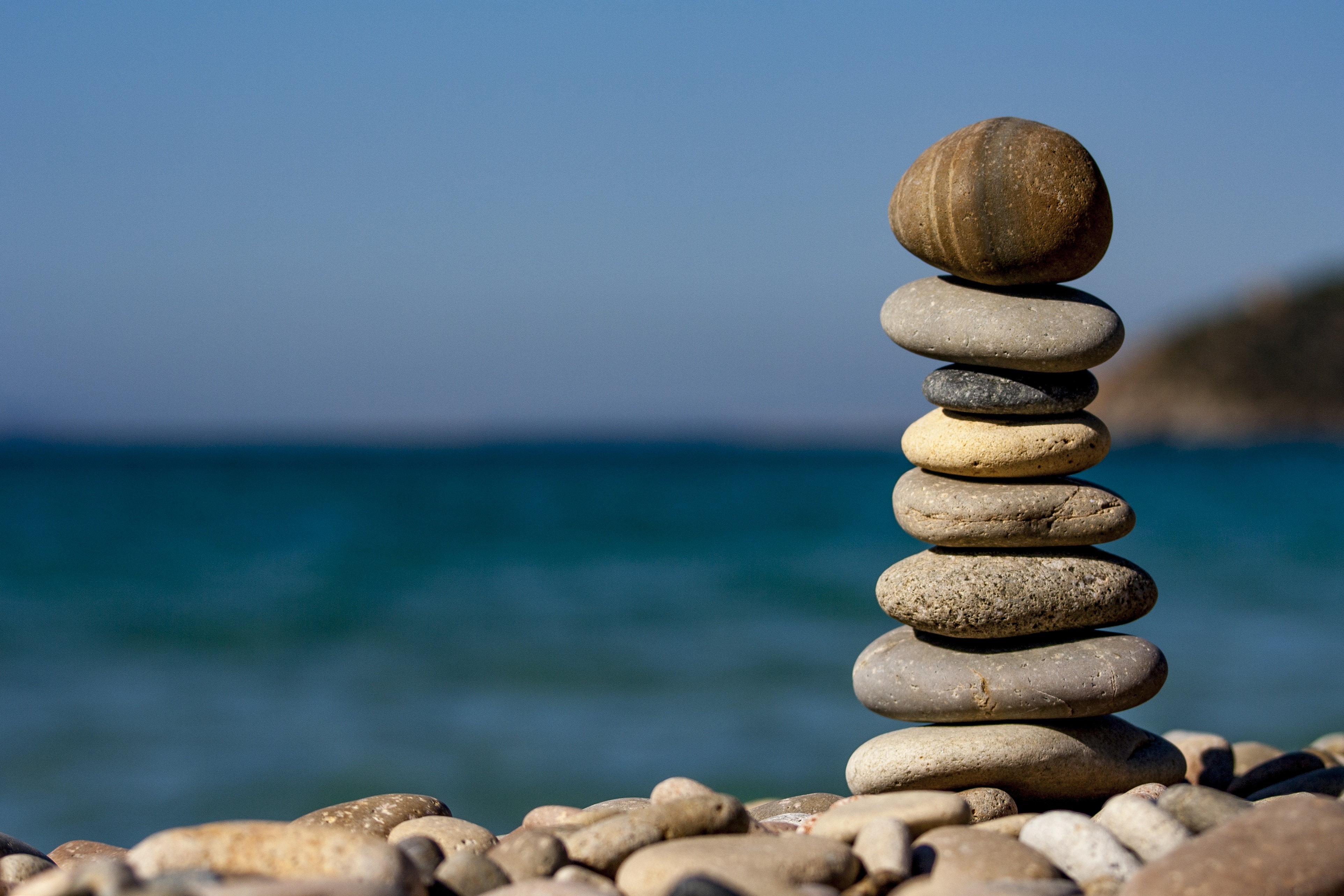 Stones evenly stacked on a beach