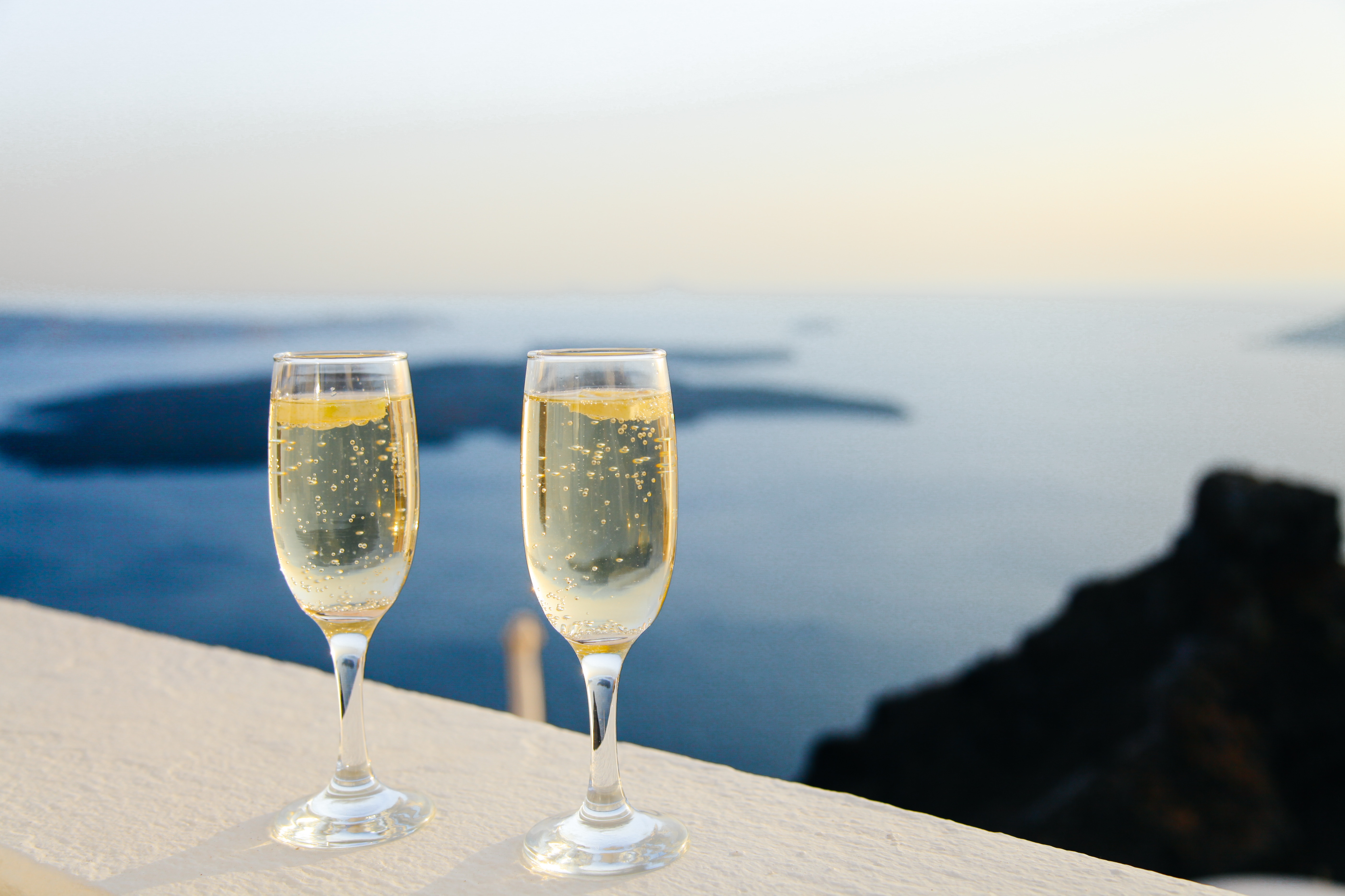 Glasses of dry Prosecco over a beach