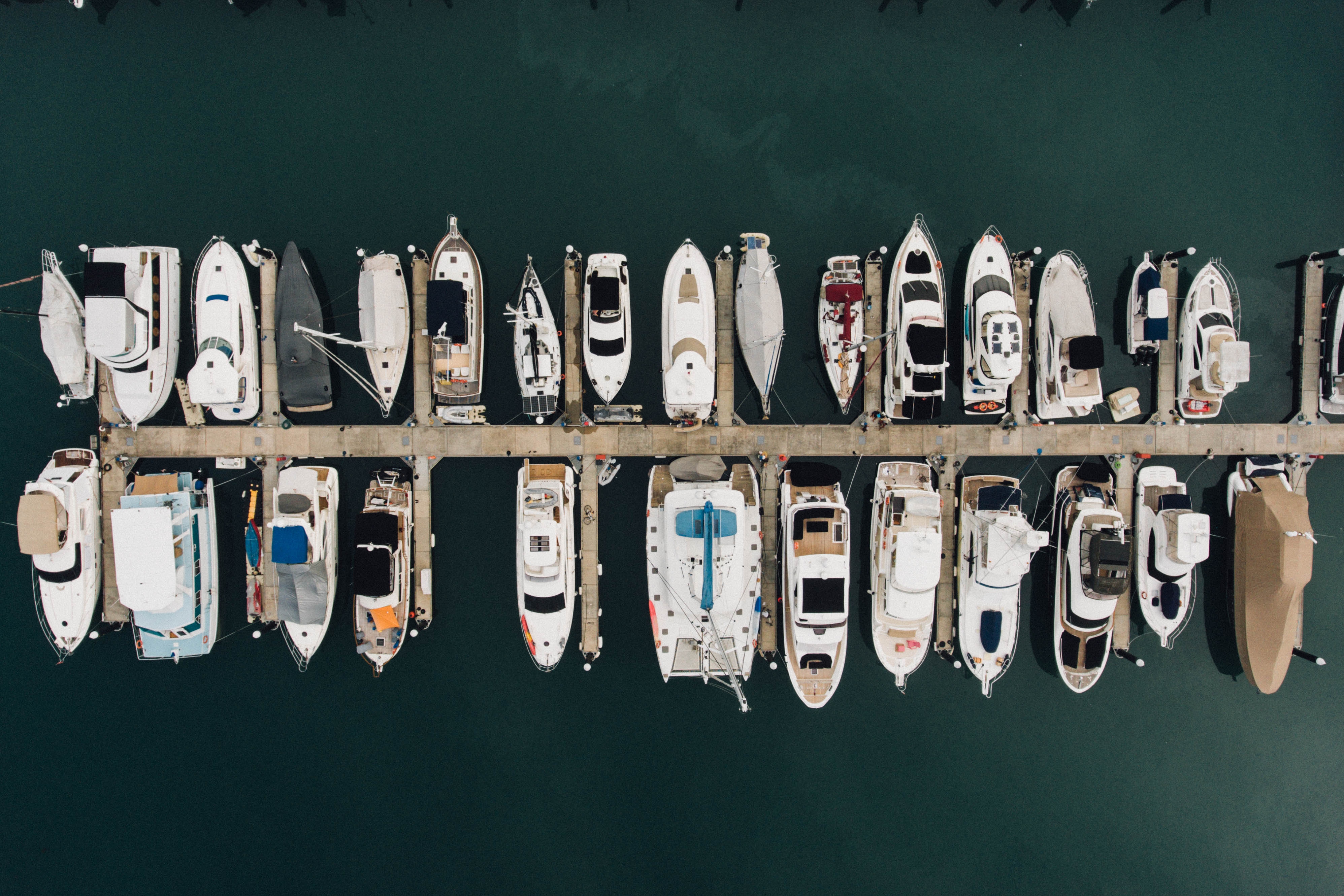 Boats parked in a pier from above in a plane