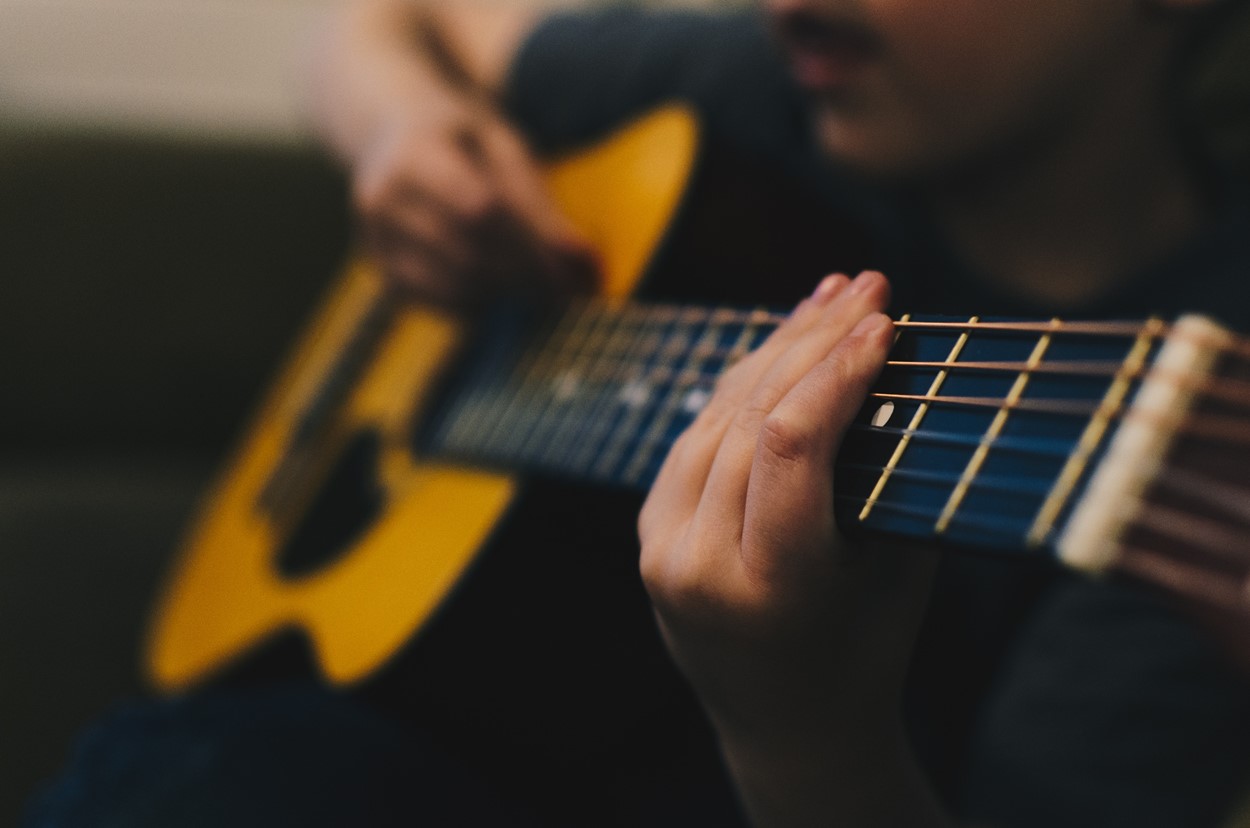 Man playing acoustic guitar at Fishguard Folk Festival