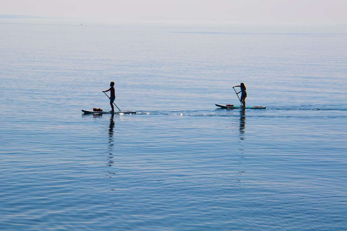 Two people paddle boarding