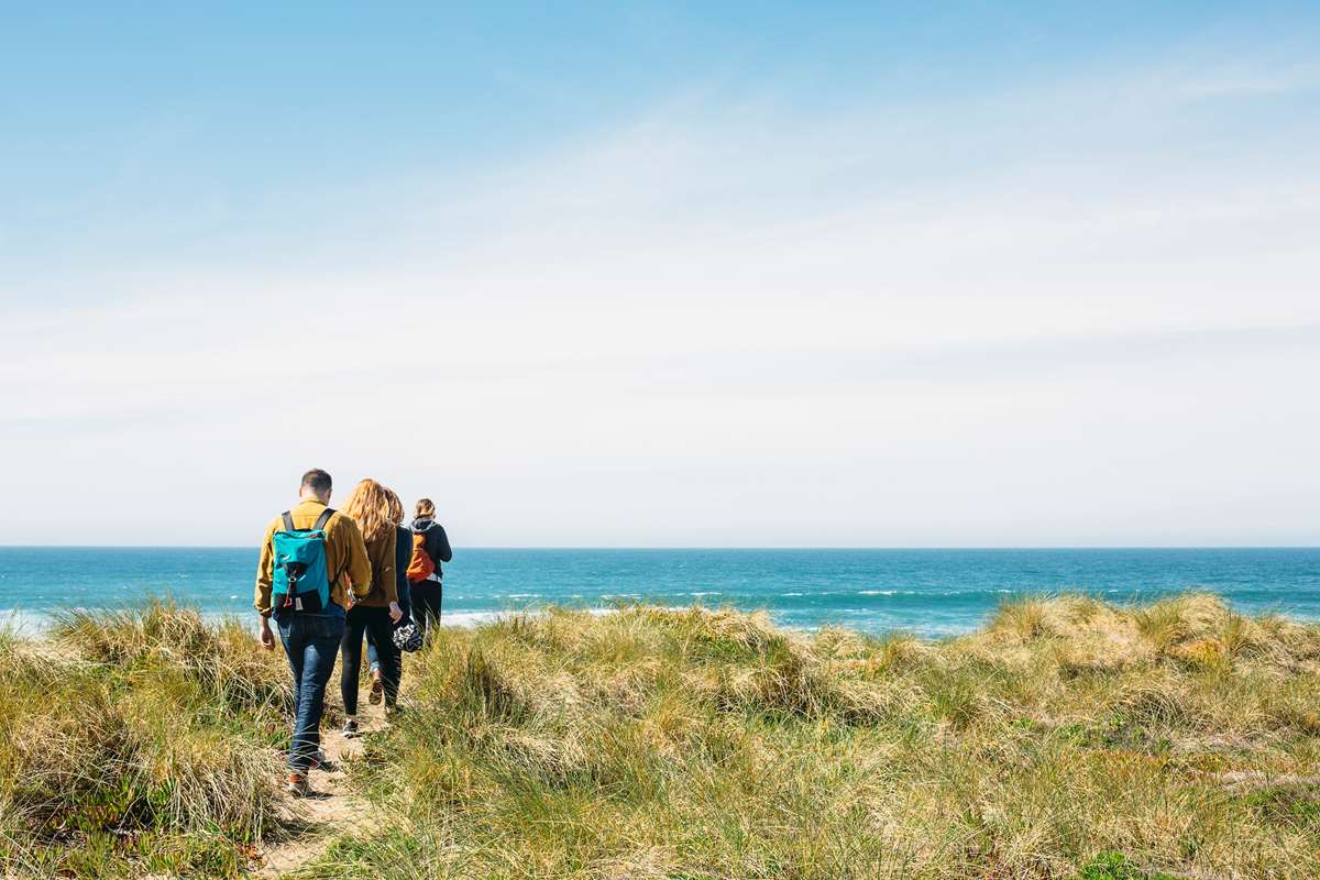Walkers exloring the beach at Freshwater West Pembrokeshire