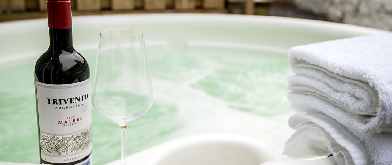 Bottle of wine next to a Hot Tub