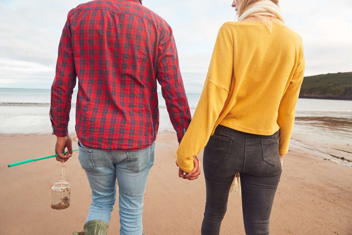 Couple on a a beach in Pembrokeshire