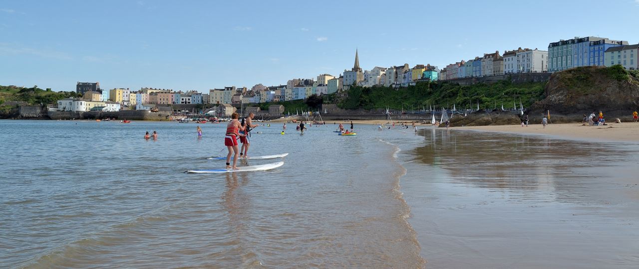 People enjoying the seaside in the Year of Outdoors in Tenby, Wales