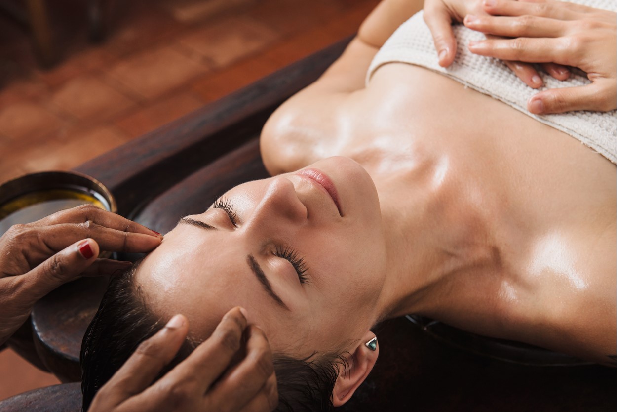 Woman enjoying a spa treatment at her holiday cottage