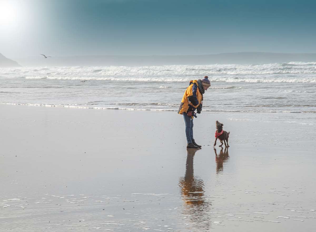Woman and dog at Newgale Beach, Pembrokeshire