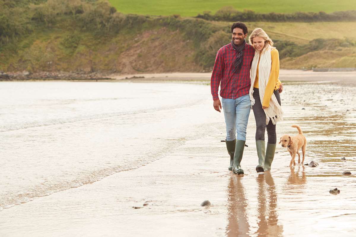 romantic couple and dog on beach