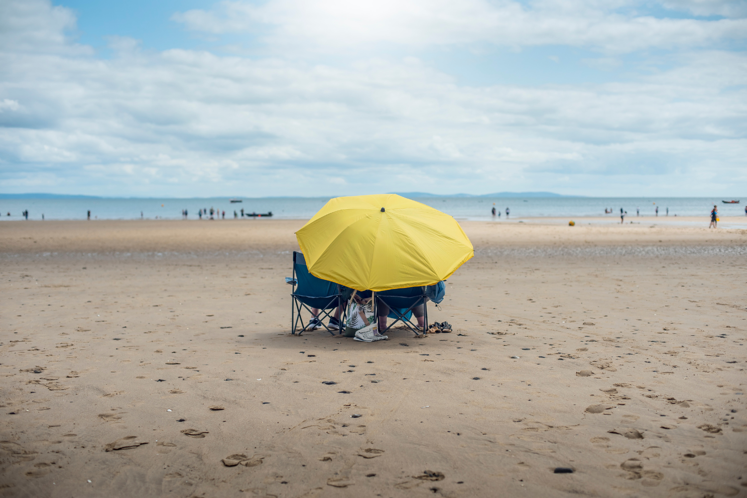 Couple on the beach in Saundersfoot on a rainy day